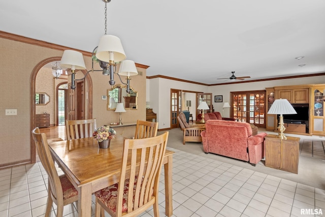 tiled dining area featuring ceiling fan and ornamental molding