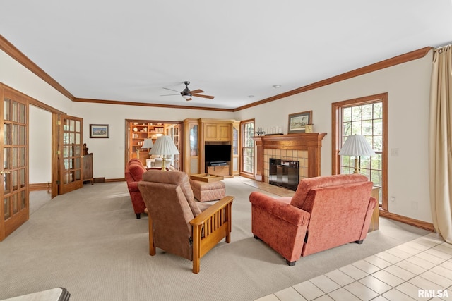 living room featuring light carpet, a fireplace, ornamental molding, and ceiling fan