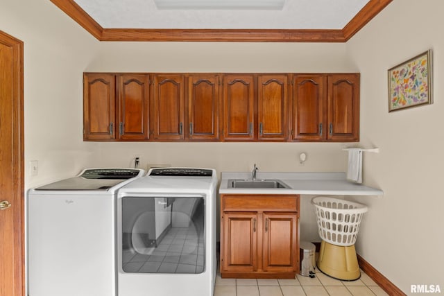 laundry room featuring cabinets, sink, separate washer and dryer, light tile patterned floors, and ornamental molding