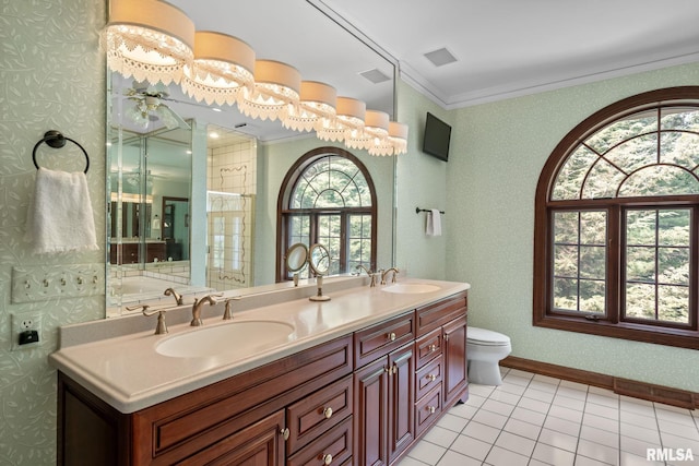 bathroom featuring tile patterned flooring, vanity, toilet, and crown molding