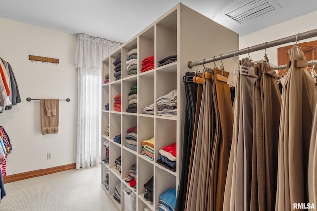 spacious closet featuring light carpet