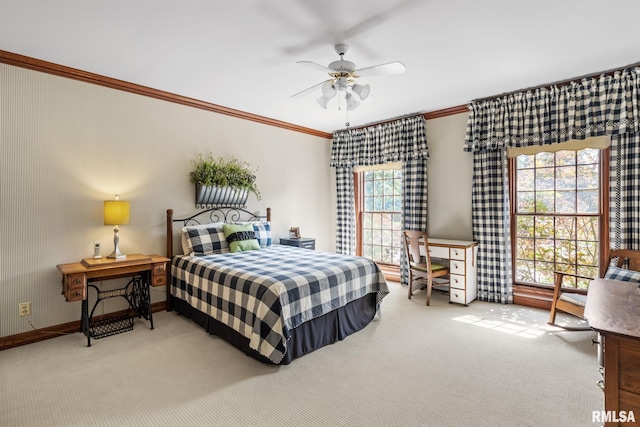 carpeted bedroom featuring multiple windows, ceiling fan, and crown molding