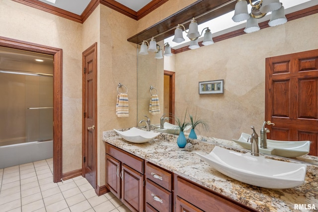 bathroom featuring crown molding, tile patterned flooring, vanity, and enclosed tub / shower combo