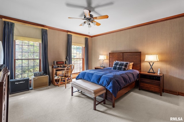 carpeted bedroom with ceiling fan and ornamental molding