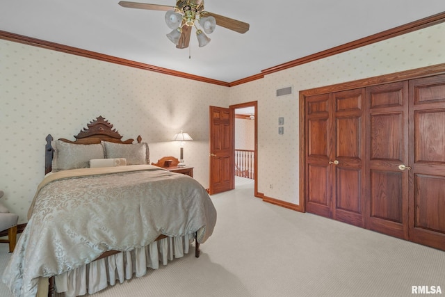 carpeted bedroom featuring ceiling fan and ornamental molding