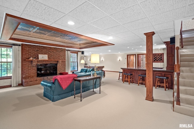 living room with light colored carpet and a brick fireplace