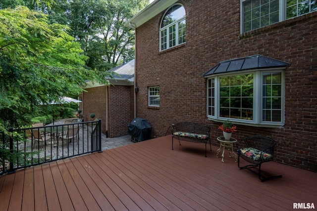 wooden deck with grilling area