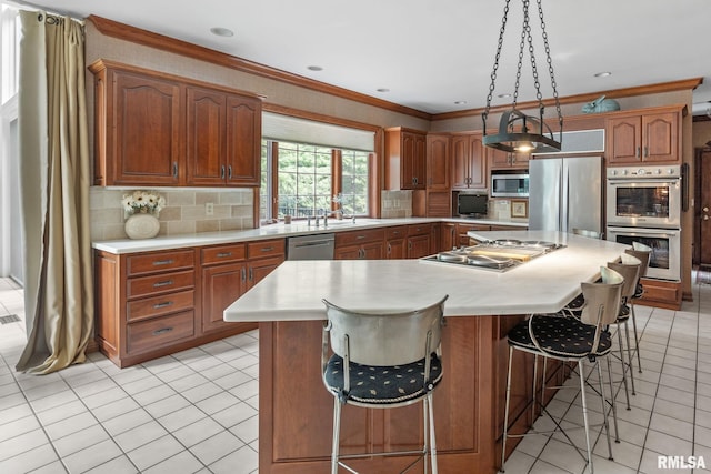 kitchen featuring appliances with stainless steel finishes, a kitchen island, and ornamental molding