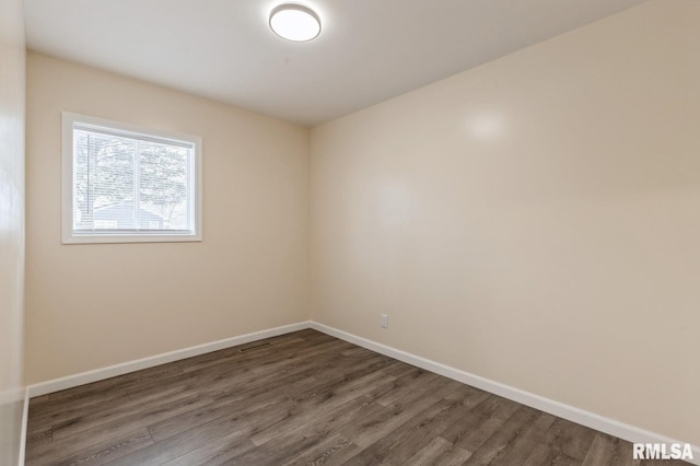 unfurnished room featuring dark wood-type flooring