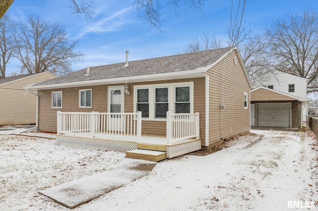 view of front of house with a garage and an outdoor structure