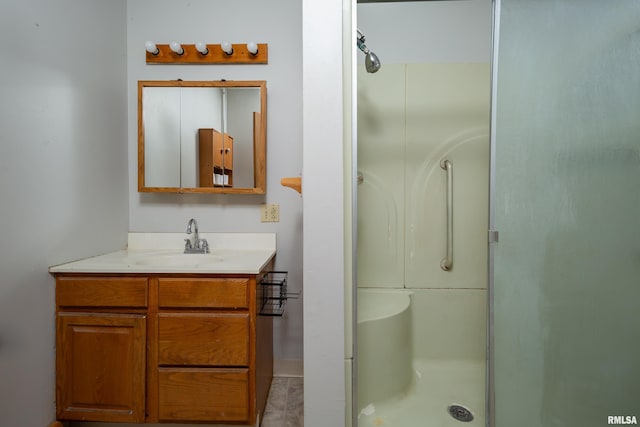 bathroom featuring vanity, tile patterned floors, and a shower with door