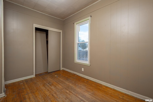 unfurnished bedroom featuring hardwood / wood-style floors and a closet