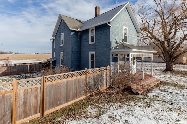 snow covered property with a wooden deck