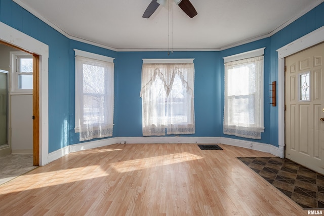 foyer with wood-type flooring, ceiling fan, and ornamental molding