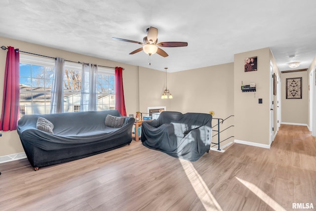 living room featuring light hardwood / wood-style flooring and ceiling fan