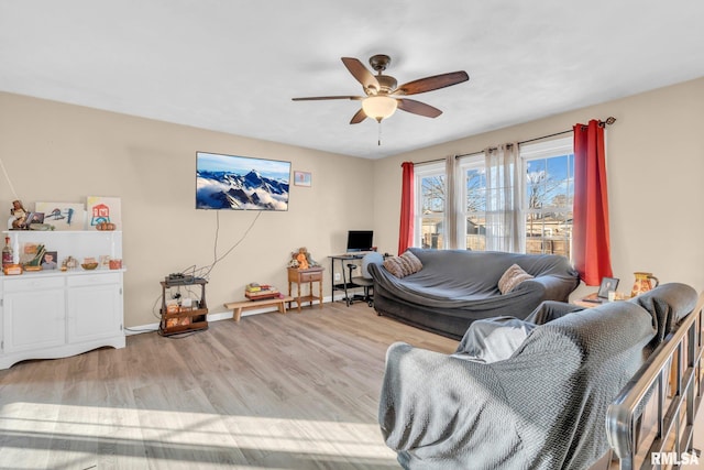 living room featuring ceiling fan and light hardwood / wood-style flooring