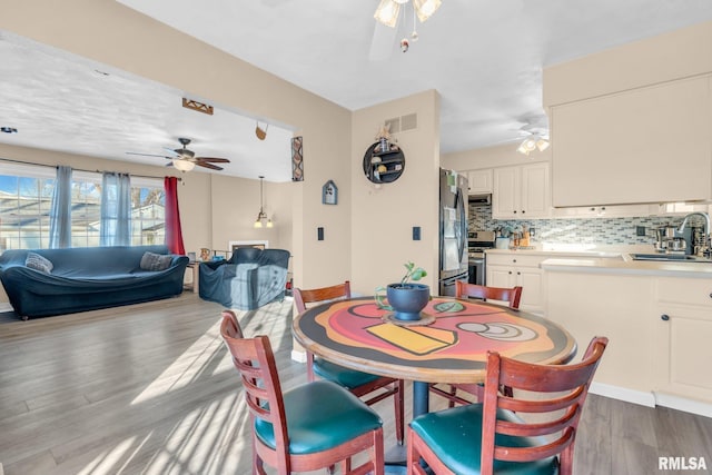 dining space featuring hardwood / wood-style flooring and sink