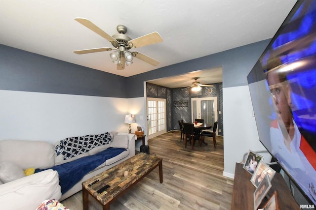 living room featuring french doors, hardwood / wood-style flooring, and ceiling fan