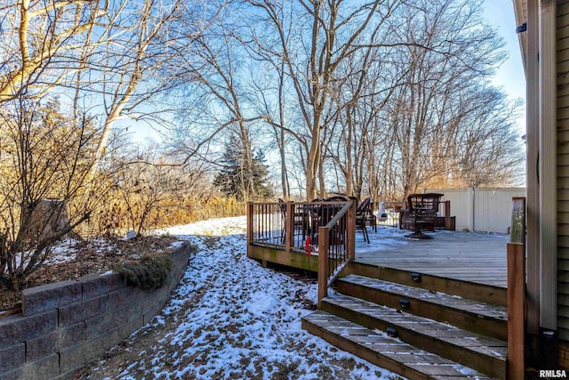 yard covered in snow featuring a deck