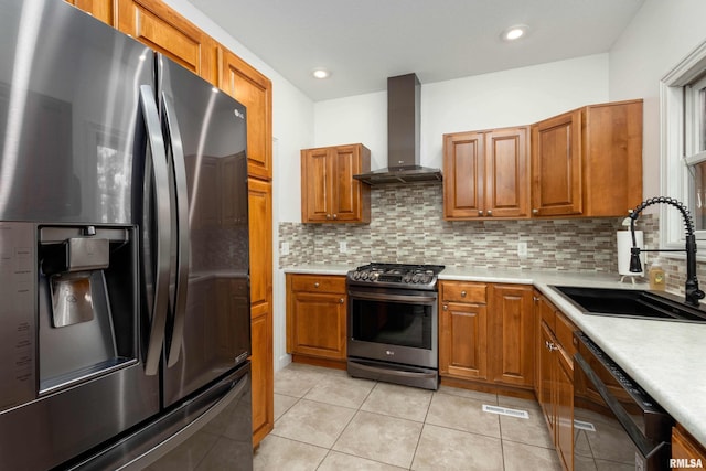 kitchen featuring backsplash, wall chimney exhaust hood, stainless steel appliances, sink, and light tile patterned flooring