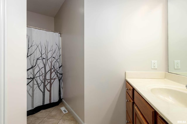 bathroom featuring tile patterned flooring and vanity