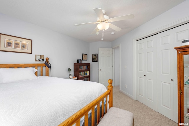 bedroom featuring ceiling fan, a closet, and light carpet