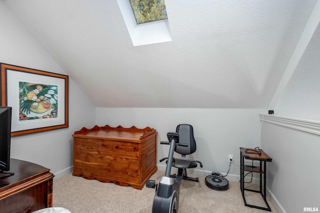 carpeted office featuring a textured ceiling and lofted ceiling with skylight