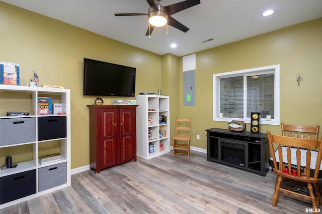 interior space featuring light wood-type flooring, electric panel, and ceiling fan