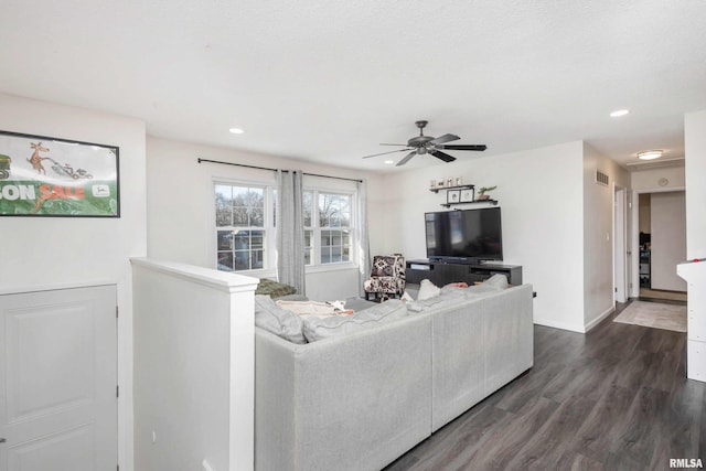 living room featuring a textured ceiling, dark hardwood / wood-style flooring, and ceiling fan