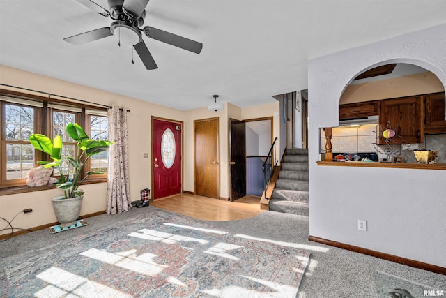 carpeted foyer featuring ceiling fan