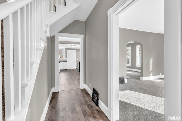 hallway with dark colored carpet