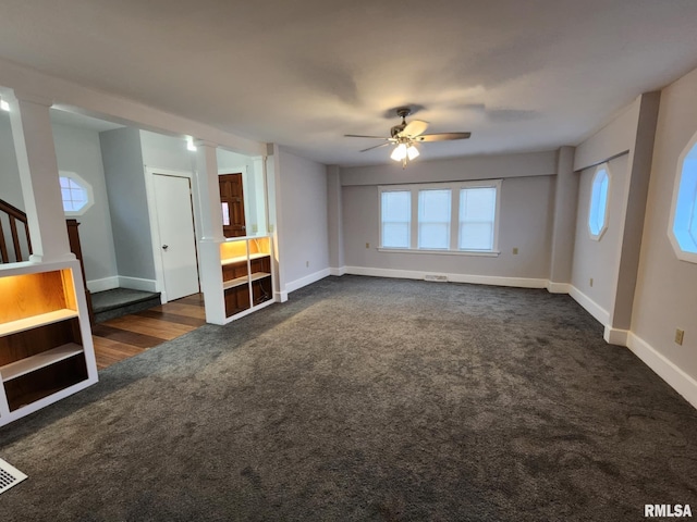 unfurnished living room featuring ceiling fan and dark carpet