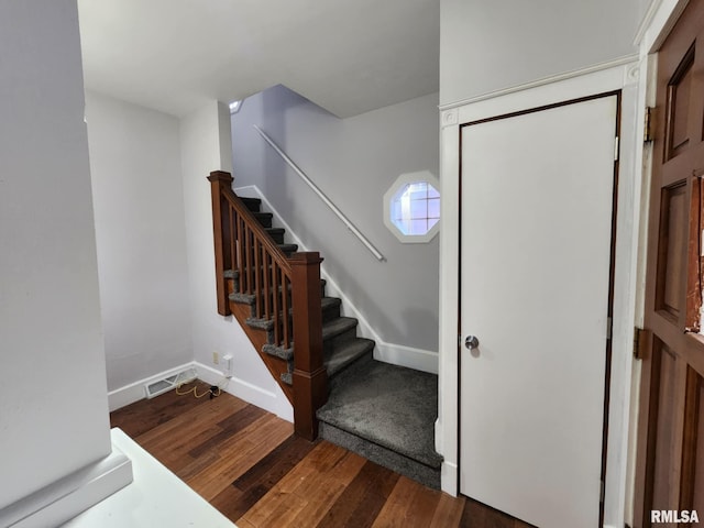 staircase featuring hardwood / wood-style flooring