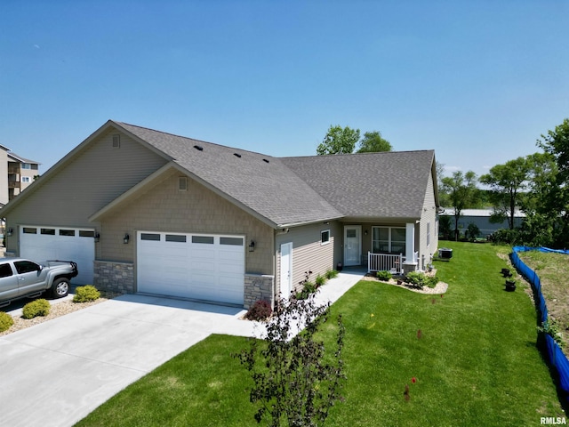 view of front of home featuring a porch, a garage, and a front yard