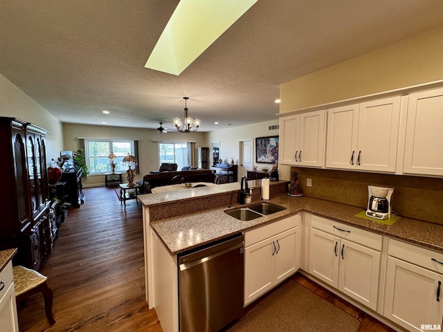 kitchen featuring white cabinets, dishwasher, kitchen peninsula, and sink