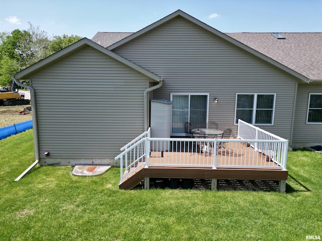 back of house with a yard and a wooden deck