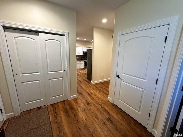 hall with dark hardwood / wood-style flooring