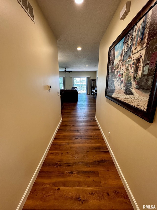 hallway with dark wood-type flooring