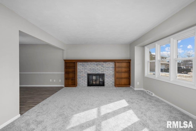 carpeted living room featuring a brick fireplace