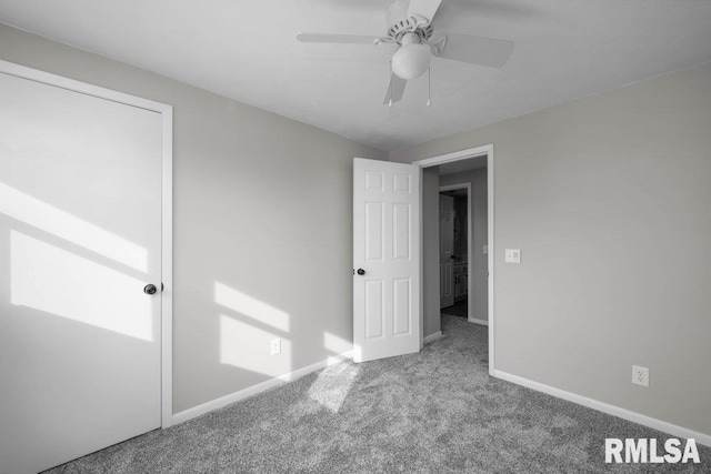 unfurnished bedroom featuring light colored carpet and ceiling fan