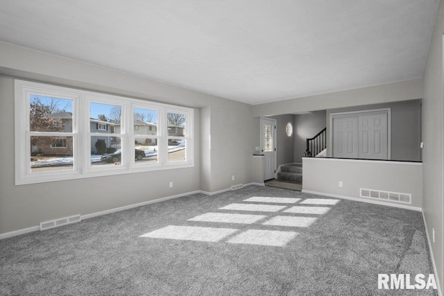 empty room featuring carpet flooring and plenty of natural light