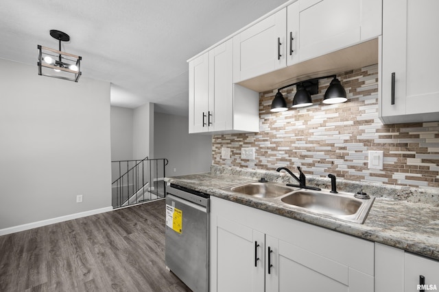 kitchen with dishwasher, white cabinetry, sink, and tasteful backsplash