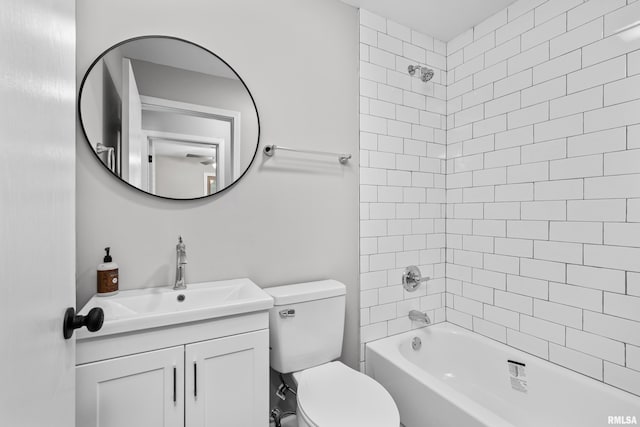 full bathroom with vanity, tiled shower / bath combo, and toilet