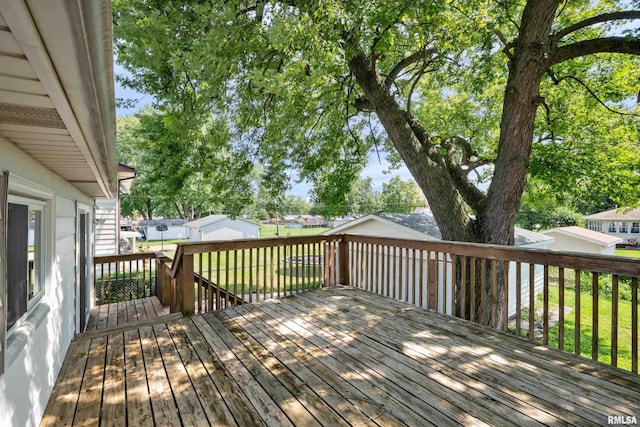 wooden terrace featuring a yard