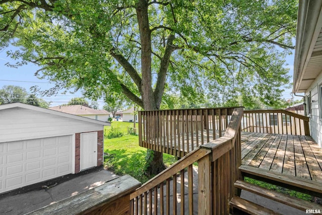 deck with a garage, an outdoor structure, and a lawn