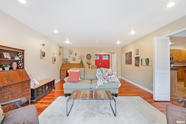 living room with baseboards, recessed lighting, and wood finished floors