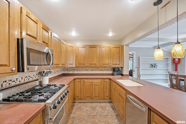 kitchen with recessed lighting, appliances with stainless steel finishes, a sink, decorative light fixtures, and backsplash