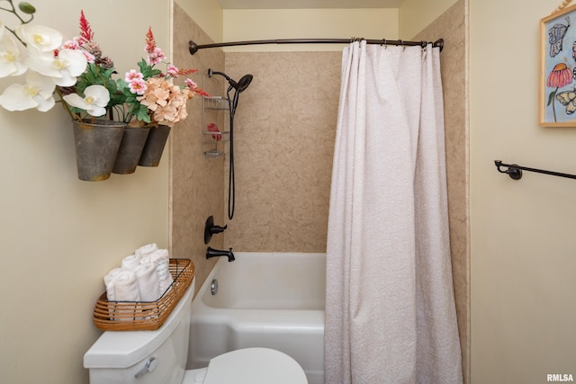 bathroom featuring shower / bath combination with curtain and toilet