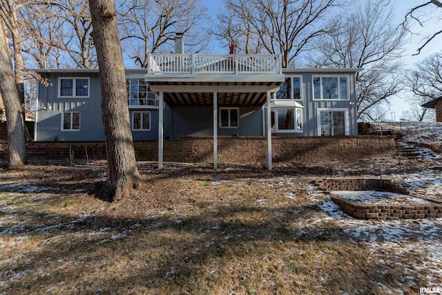 back of house with a wooden deck