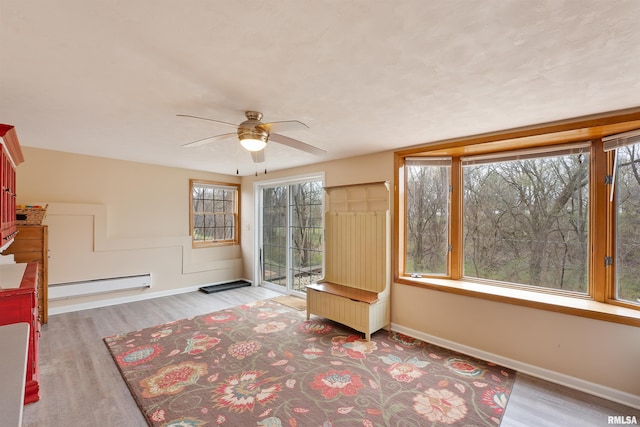 unfurnished sunroom featuring baseboard heating
